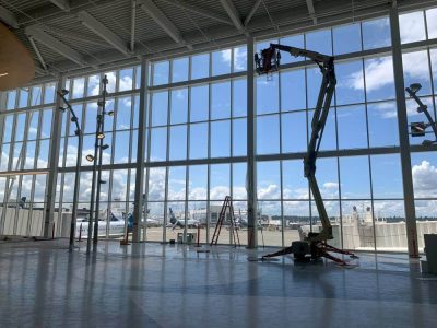 NW ProKleen professional cleaning windows inside commercial property with ladders